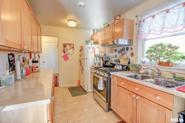 kitchen with light tile patterned flooring, light brown cabinetry, a sink, under cabinet range hood, and stainless steel gas stove