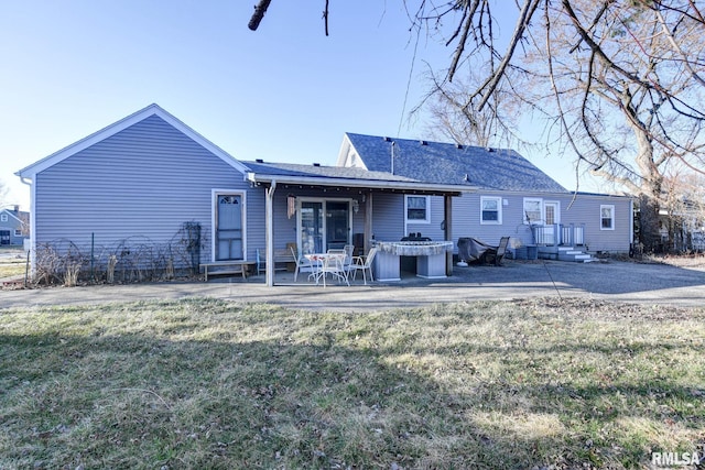 rear view of house with a yard