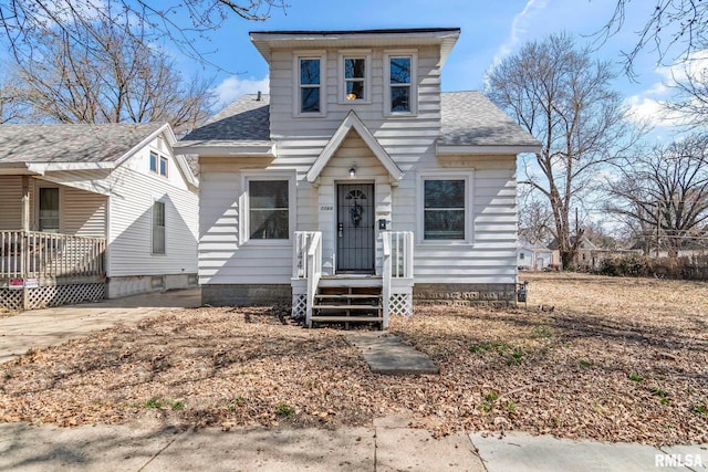 bungalow-style house featuring roof with shingles