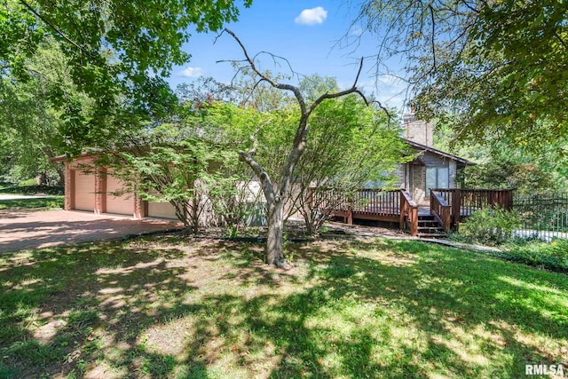 view of front of house with a front lawn, a chimney, a garage, a deck, and driveway