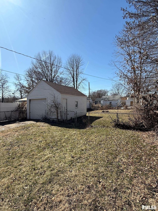 exterior space with a garage, an outdoor structure, and fence