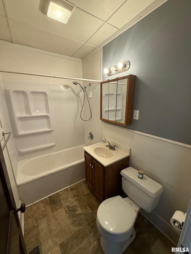 bathroom featuring vanity, visible vents, a paneled ceiling, shower / bath combination, and toilet