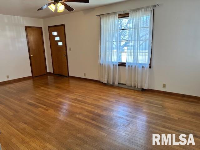 interior space featuring baseboards and wood finished floors