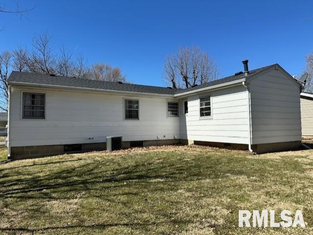 back of property with a yard and crawl space