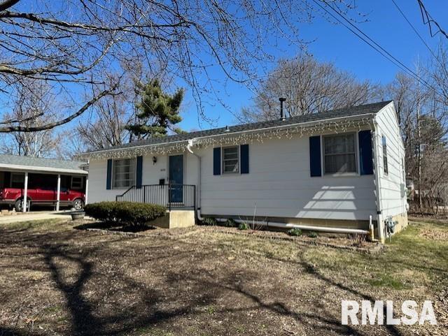 single story home featuring an attached carport