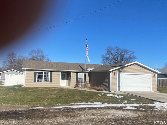 ranch-style house featuring a front lawn, an attached garage, driveway, and fence