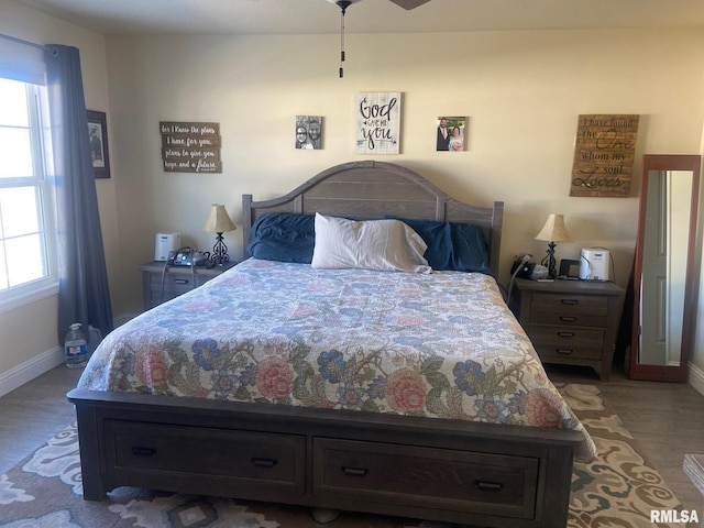 bedroom with wood finished floors and baseboards