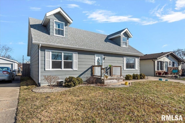 cape cod home with a front lawn and a shingled roof