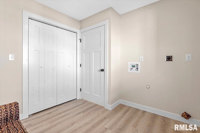 washroom with washer hookup, laundry area, baseboards, and light wood-type flooring