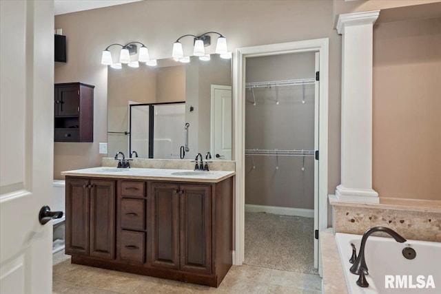 full bath with a sink, a shower stall, and ornate columns