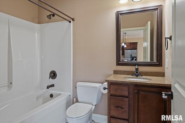 full bathroom featuring toilet, vanity, and washtub / shower combination