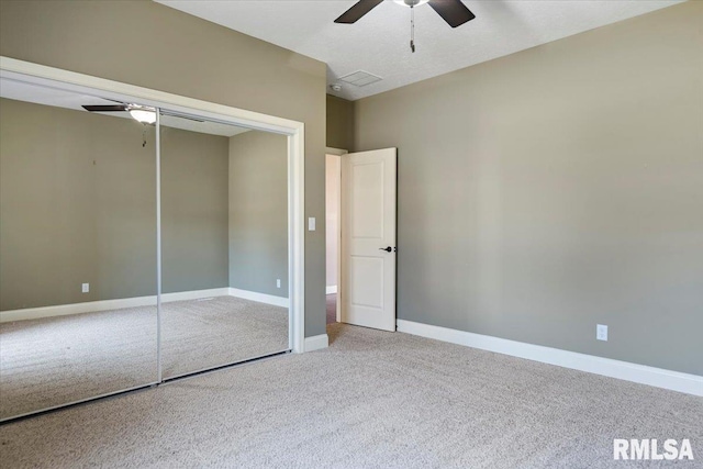 unfurnished bedroom featuring a closet, carpet flooring, a ceiling fan, and baseboards