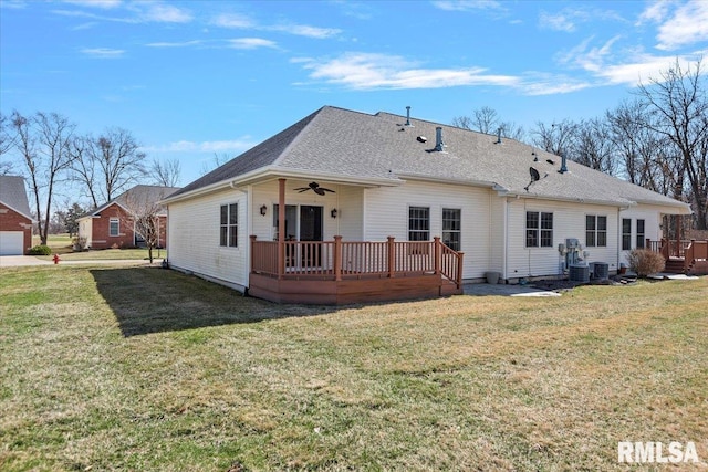 rear view of property with a ceiling fan, a lawn, and a wooden deck