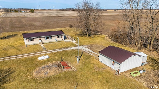 birds eye view of property with a rural view