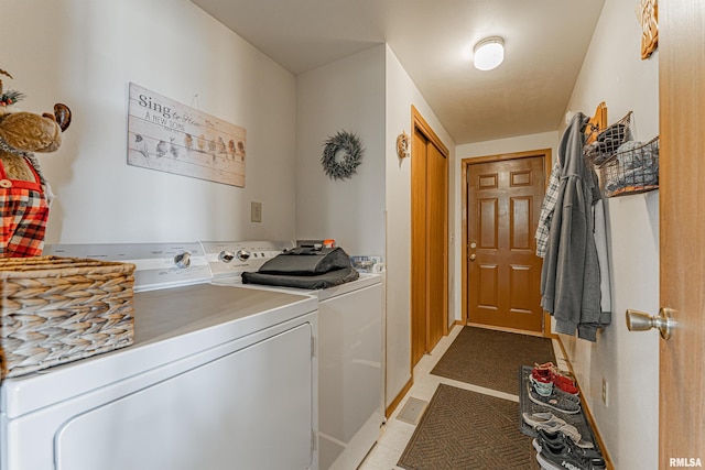 washroom featuring washer and dryer and laundry area