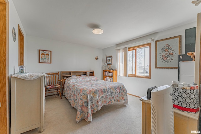 bedroom with baseboards and light carpet