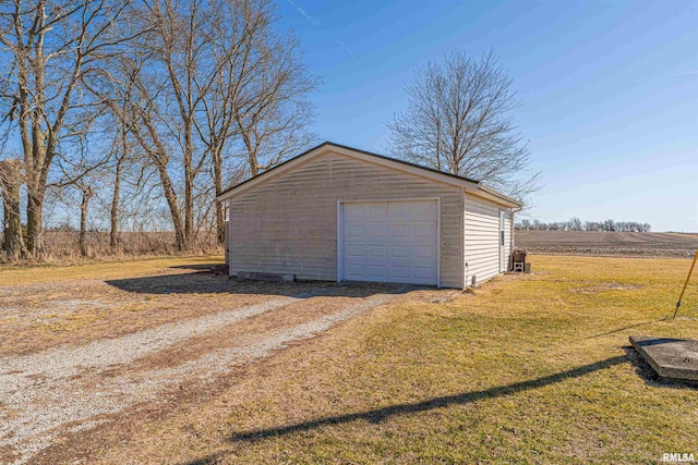 detached garage with dirt driveway