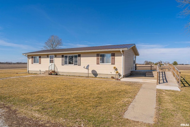 ranch-style house with metal roof, a front lawn, and entry steps