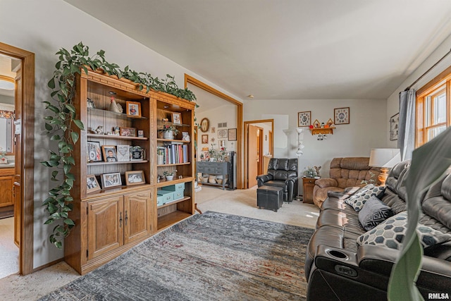 living area featuring light carpet