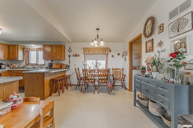 dining room with visible vents, baseboards, light floors, lofted ceiling, and a notable chandelier