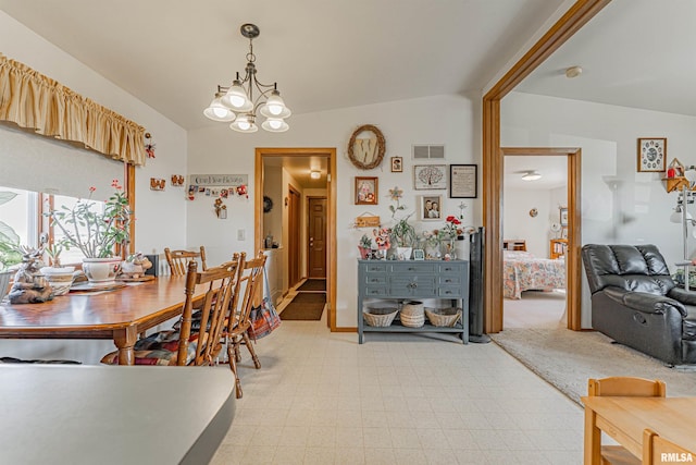 dining area with an inviting chandelier, light floors, and visible vents