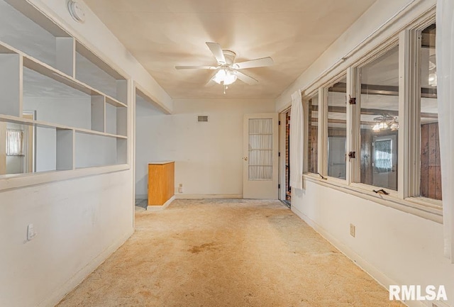 carpeted spare room with baseboards and ceiling fan