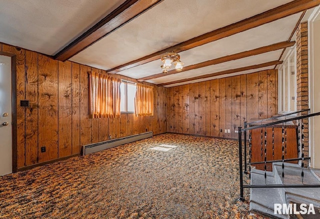 unfurnished living room with beam ceiling, wooden walls, carpet flooring, and baseboard heating