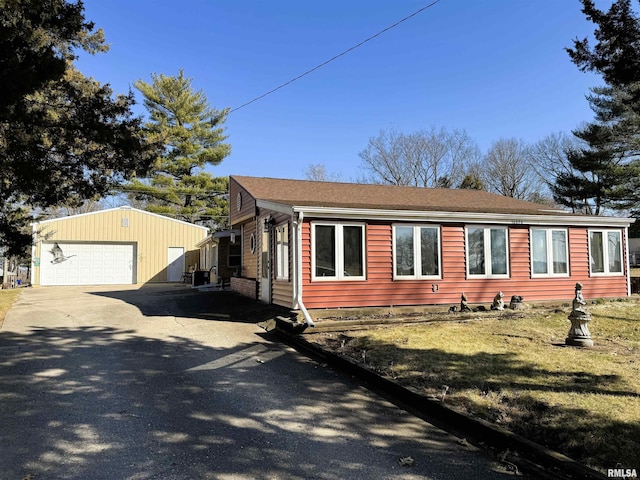 view of front of property with an outdoor structure and a garage