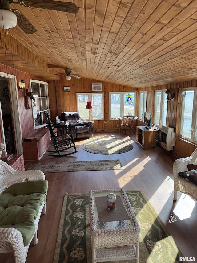 living room with wooden walls, wooden ceiling, wood finished floors, and vaulted ceiling