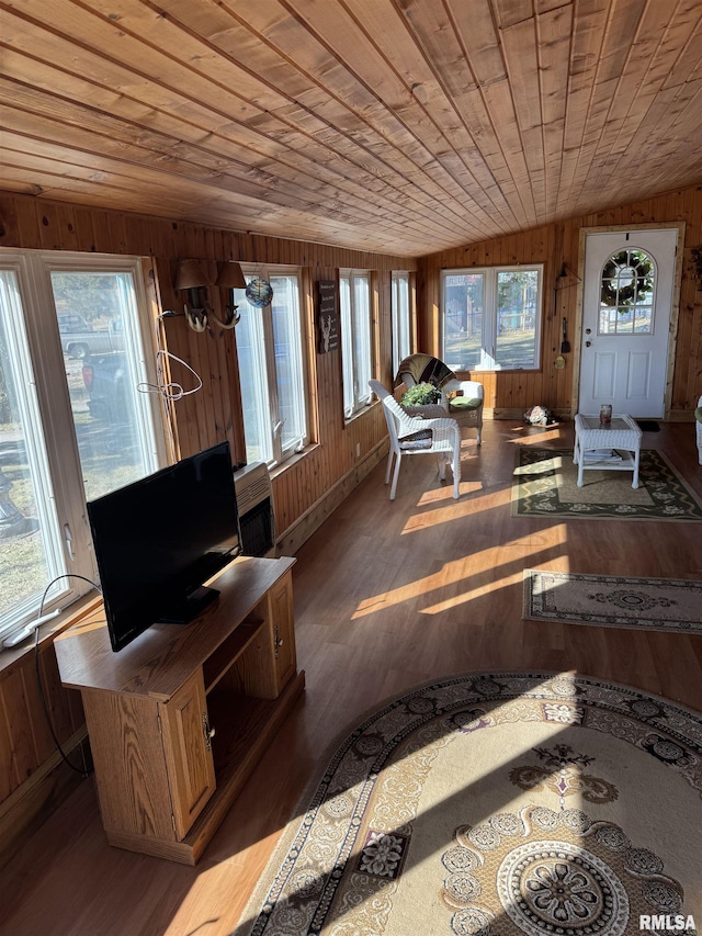 sunroom / solarium with lofted ceiling, plenty of natural light, and wood ceiling