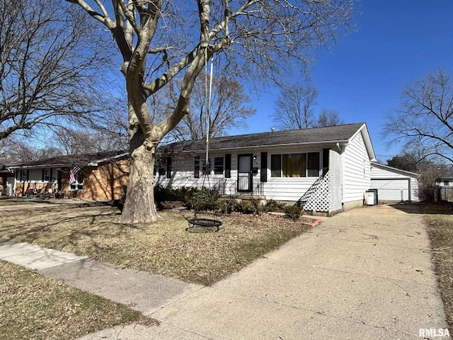 ranch-style house featuring an outbuilding, a porch, and a garage