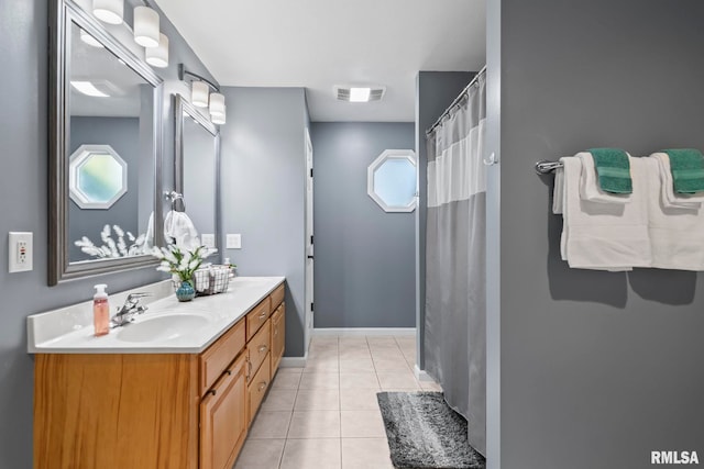 bathroom featuring a wealth of natural light, visible vents, tile patterned floors, a sink, and double vanity