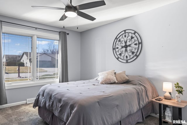 carpeted bedroom featuring visible vents, a ceiling fan, and baseboards