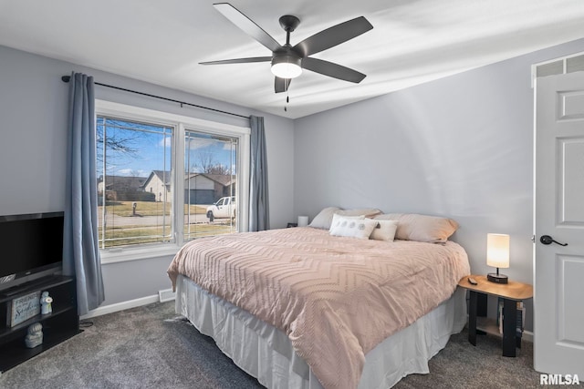 bedroom with baseboards, dark carpet, and ceiling fan