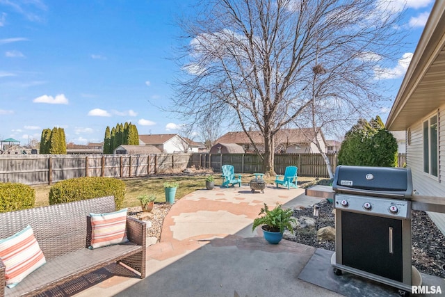 view of patio featuring a grill, a fire pit, and fence