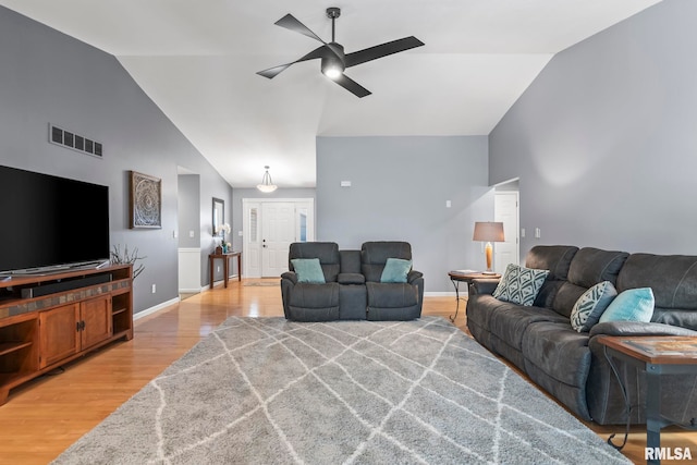 living room featuring visible vents, high vaulted ceiling, light wood-style flooring, a ceiling fan, and baseboards