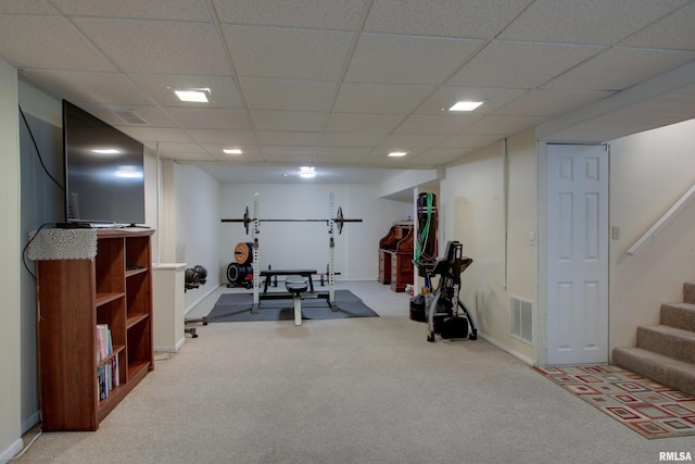 workout room with a drop ceiling, baseboards, visible vents, and carpet floors