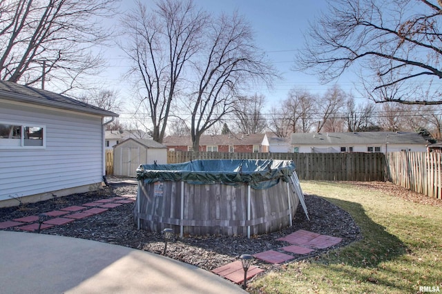 view of yard with an outbuilding, a shed, a fenced in pool, and a fenced backyard