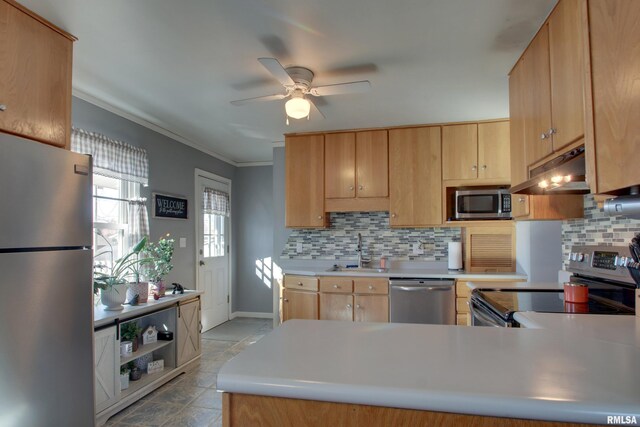 kitchen with a sink, stainless steel appliances, light countertops, under cabinet range hood, and backsplash