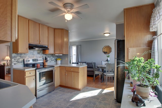 kitchen featuring a peninsula, stainless steel appliances, decorative backsplash, light countertops, and under cabinet range hood