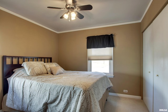 carpeted bedroom with a ceiling fan, baseboards, and ornamental molding