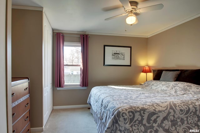 bedroom with light colored carpet, a ceiling fan, crown molding, and baseboards