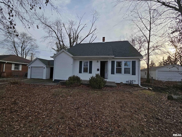 view of front of home with an outdoor structure, roof with shingles, and a chimney