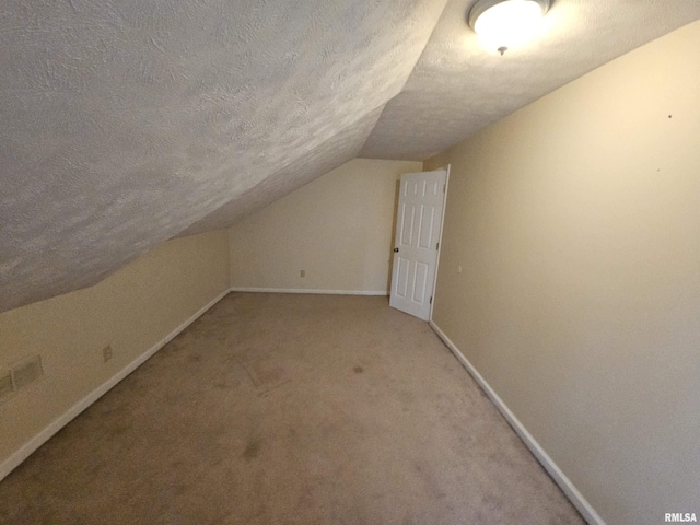 bonus room featuring baseboards, light carpet, a textured ceiling, and vaulted ceiling