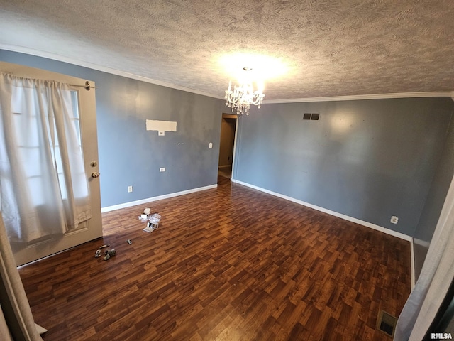 unfurnished room featuring wood finished floors, baseboards, ornamental molding, a textured ceiling, and a chandelier