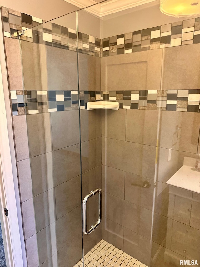 bathroom with a stall shower and ornamental molding