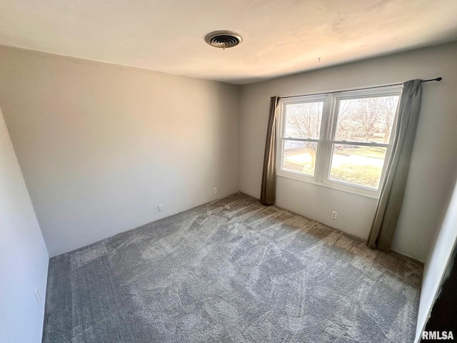 carpeted spare room with visible vents