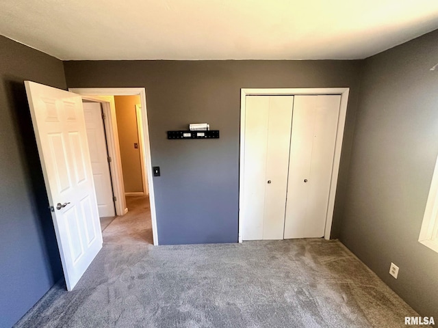 unfurnished bedroom with a closet and carpet