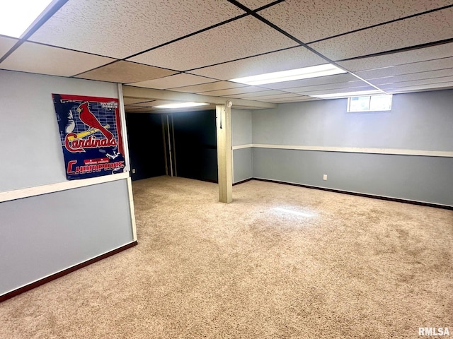 below grade area featuring baseboards and carpet