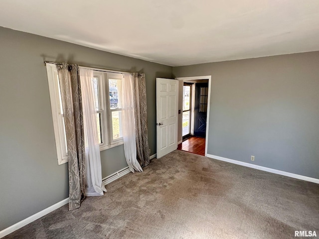 carpeted empty room with baseboards